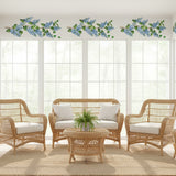 Free Flowing Lilac Branch Wall Stencil Border painted onto a wall in a well lit sunroom.