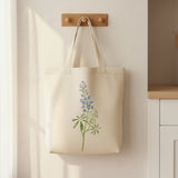 White Canvas Bag with Texas Bluebonnet Stencil Painted on it.