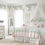 Hydrangea and Rose Wall Stencil Border repeated along the top of a wall in a bedroom.