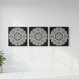 White floral mandala pattern on black painted canvas
