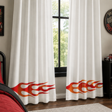Curtains that have been painted with reusable flame accent stencil in a room decorated with a car theme.