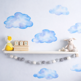 Children's room with cloud wall decals, toys, and a shelf.