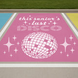 Pink sign with 'this senior's last DISCO' text and disco ball graphic on  parking lot