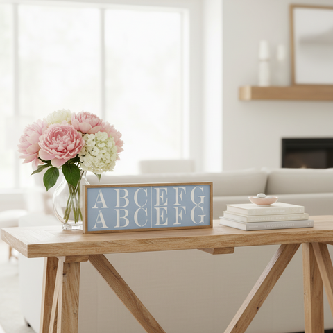 Decorative sign with letters on a wooden table in a living room setting