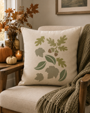 Leaves stenciled onto a pillow in a room with fall decor