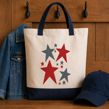 Tote bag with star design on a wooden surface with denim jacket and cap.