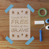 Wooden sign with 'land of the free home of the brave' text on a wooden surface