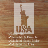 Laser cut plastic mylar with Statue of Liberty design on a wooden surface