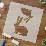 Bunny Stencil surrounded with painters tape, acrylic paint and paint rollers.