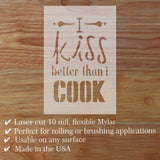 Laser cut Mylar sheet with text 'I kiss better than I cook' on a wooden surface.
