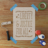 Wooden sign with 'Liberty & Justice for All' text on a wooden surface