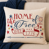 Decorative pillow with 'Home of the Free, est. 1776' text on a couch.
