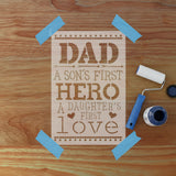 Decorative sign with text 'DAD A SON'S FIRST HERO A DAUGHTER'S FIRST LOVE' on a wooden background