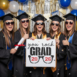 Graduation-themed design with sunglasses and text 'you rock GRAD 2026' on a white background