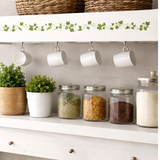 White shelf with jars of spices, plants, and mugs on a neutral background