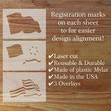Stencils with laser-cut shapes and text on a wooden background