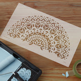 Mandala stencil surrounded by paint in preparation for painting