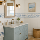 Bathroom with blue vanity, sink, and window overlooking the ocean.