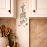 Kitchen counter with herbs decal on wall, wooden utensils, and ingredients.