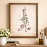 Framed botanical illustration on a wall with a cup, books, and bottles on a shelf below.