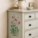 Vintage-style dresser with floral painting and decorative items on top