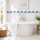 Pompeii Wave Scroll stenciled onto a wall behind a tub in a bright and sunny bathroom
