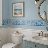 Bathroom with blue walls, white toilet, sink, and decor elements.