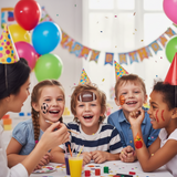 Children at a birthday party with face paint and balloons