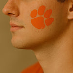 football fan with a Tiger Mascot Face Painting Stencil painted onto his cheek.