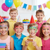 Children with face paint at a birthday party, wearing party hats and holding cake.