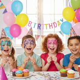 Children with face paint at a birthday party with balloons and cake.