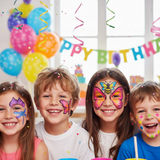 Children with butterfly face paint at a birthday party with balloons and decorations.