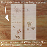 Two plastic stencils with registration marks on a wooden surface
