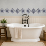 White freestanding bathtub with vintage-style faucet in a bathroom setting.