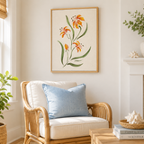 Cozy living room with a wicker chair, floral artwork, and decorative items.