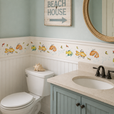 Bathroom with decorative fish wall stickers, a sink, and a 'Beach House' sign.