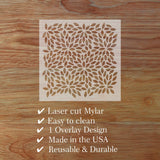 Laser cut Mylar overlay design on a wooden surface with product features listed.