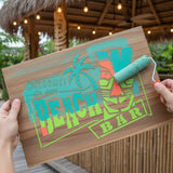 Welcome to Our Beach Bar Outdoor Stencil being stenciled onto a sign for a tiki bar