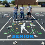 Three students standing next to a senior class parking spot with decorations, including 'Class of 2026' and 'Senior' text.