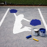 Parking space personalized with a stenciled cheerleader  painted in the middle of it.