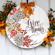 Round Thanksgiving sign stencil with autumn leaves and 'Give Thanks' text for decorative home décor.