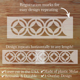 Decorative border stencil with registration marks on a wooden surface