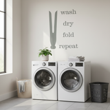 Laundry room with washing machines, a plant, and laundry items.