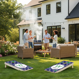People enjoying a barbecue in a backyard with cornhole boards.