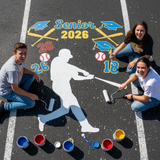 Three students painting a senior 2026 mural on a parking lot with sports-themed decorations.