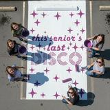 'this senior's last disco' stencil applied with a roller and purple paint onto a white painted parking spot.
