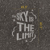 'The Sky is the Limit' stencil text with measurements on pavement.