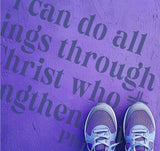 Person standing on pavement that has been stenciled with the Philippians Bible Verse.