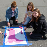Cowboy Boot stenciled on pavement with matching parking space stencil.