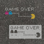 Pixelated 'Game Over' screen with Pac-Man characters on an asphalt surface